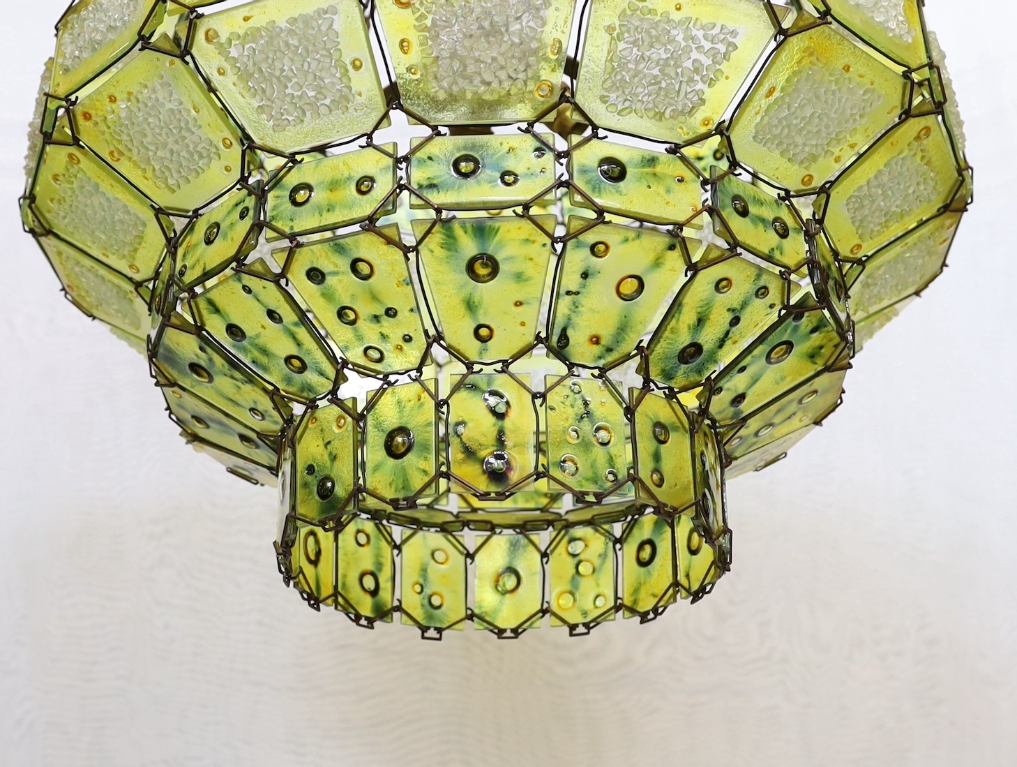 A 1930s Venetian panelled green glass light fitting with central light bulb holder, drop from rose 65cm. width 50 cm